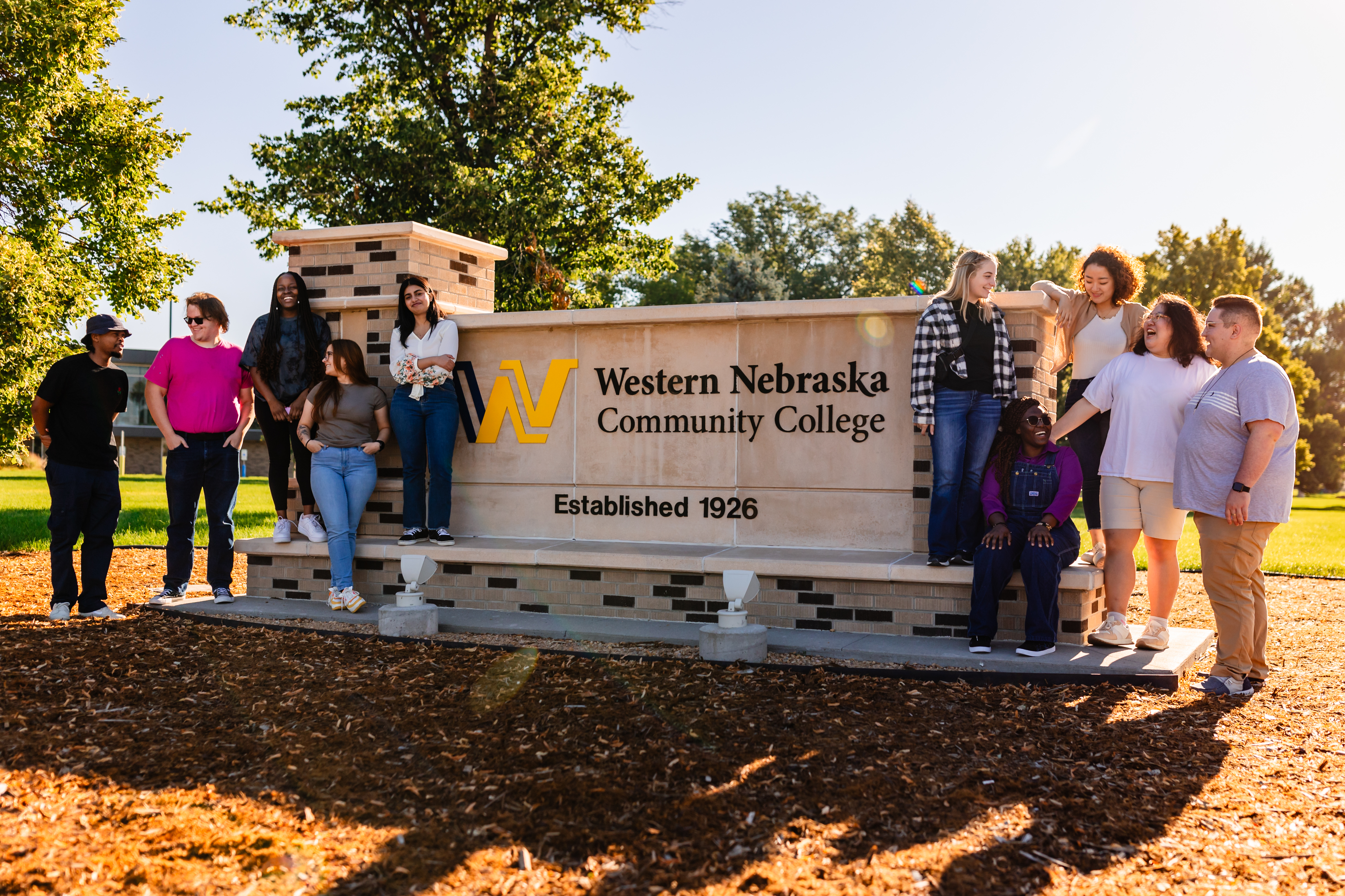 Students standing by WNCC sign